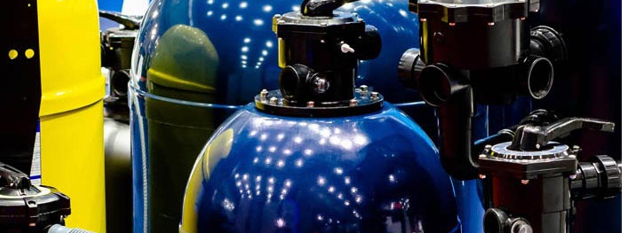 Pool and spa electrical systems components, including blue and yellow tanks, pumps, and valves, highlighting essential equipment for safe and efficient operation.